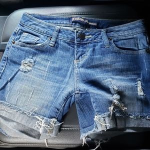 Distressed denim cutoff shorts.